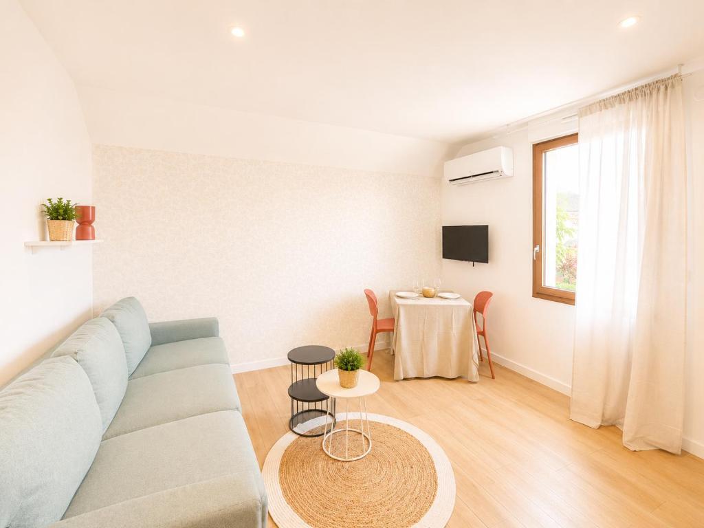 a living room with a couch and a table at M114 Magnifique T2 aux portes de la douane de Moillesulaz in Gaillard