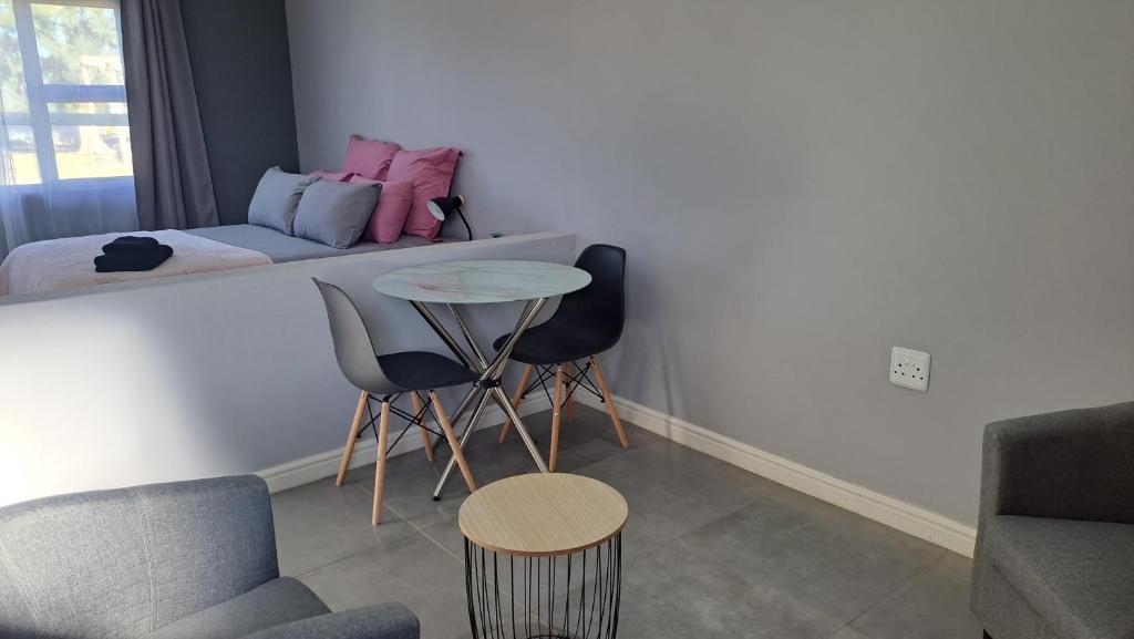 a living room with a table and chairs and a bed at Aqua Farm - Unit 3 in Teba