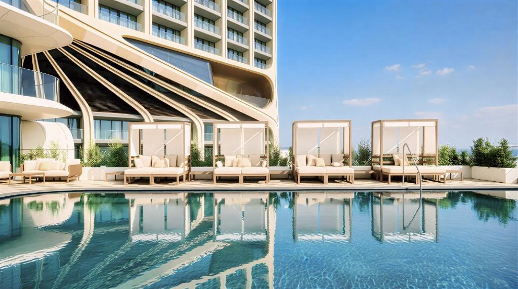a swimming pool in front of a building at Mercury Suites - Skydream Getaways in St. Julianʼs