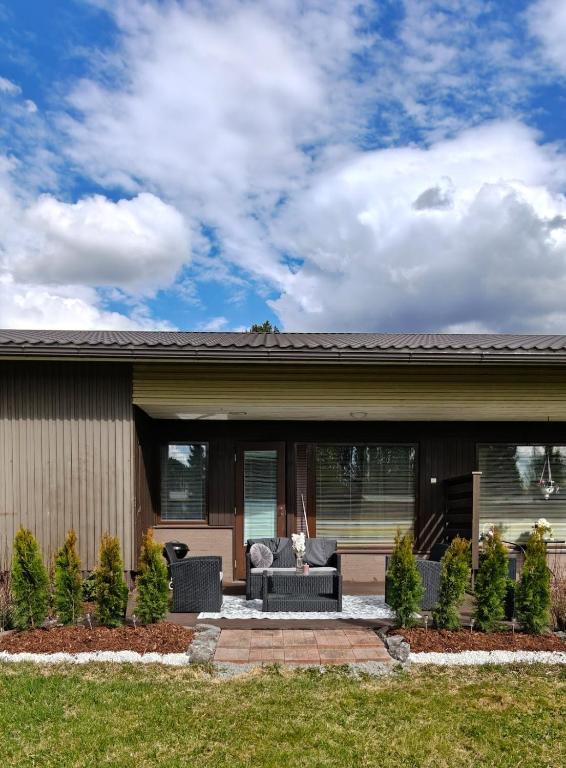 a house with a couch and chairs in front of it at Sorvarinraitin Helmi in Seinäjoki