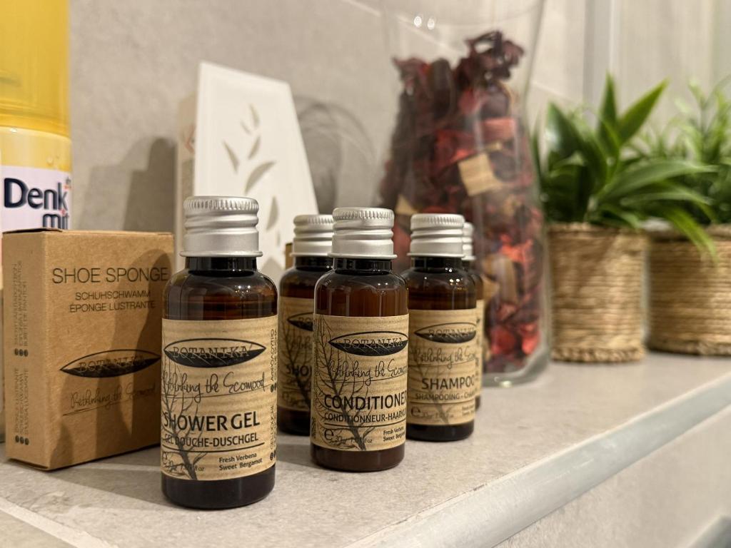 four bottles of honey sitting on a shelf at Mnd Aqua Nest in Zalakaros