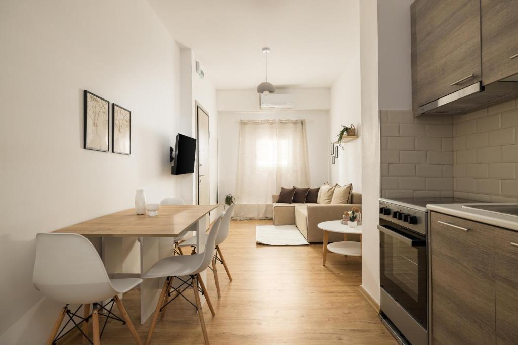a kitchen and living room with a table and chairs at Ourania Lofts and Suites in Thessaloniki