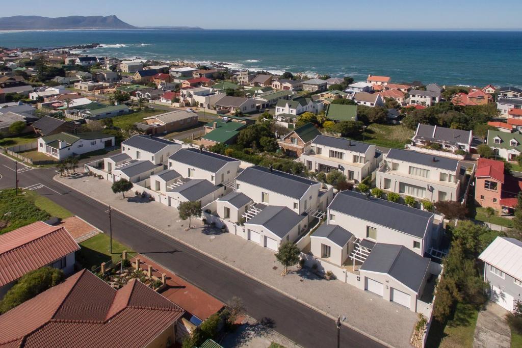 an aerial view of a town with houses and the ocean at Spatalla Holiday Homes in Kleinmond