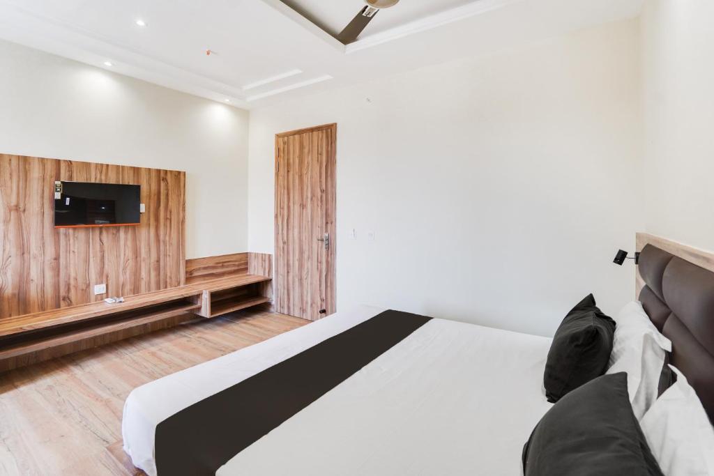 a bedroom with a bed and a tv on the wall at Hotel O Hotel Shiv Lok in Kaliānpur