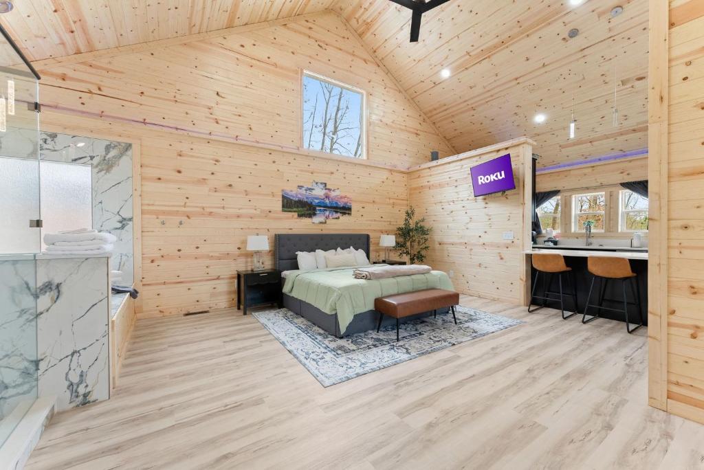 a room with a bed and a sink in it at Hilltop Haven Treehouse in Cornelia
