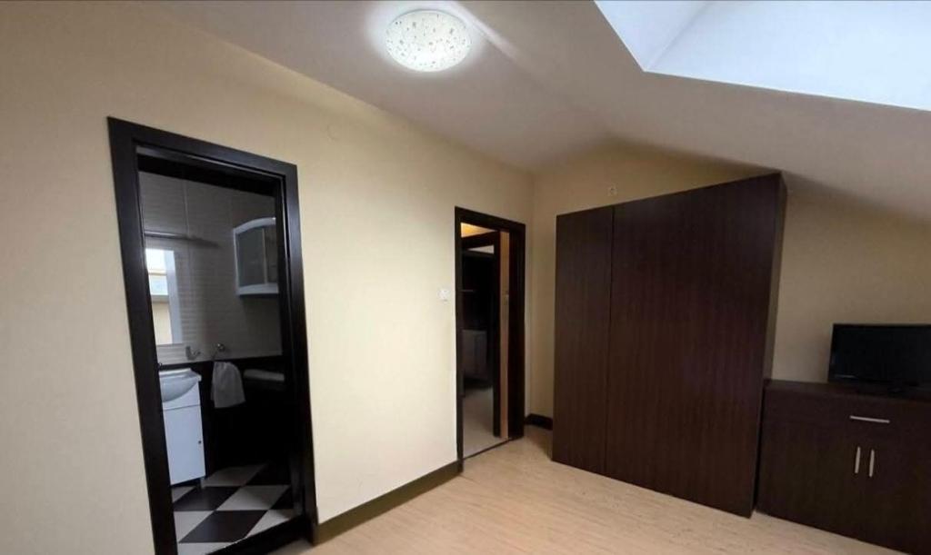 a room with a door and a room with a ceiling at Alfa Mall in Sibiu