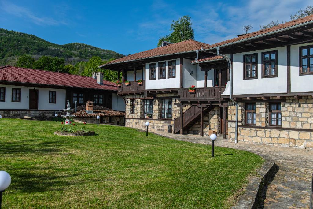 a building with a grass yard in front of it at Хотелски комплекс Усоето in Elena