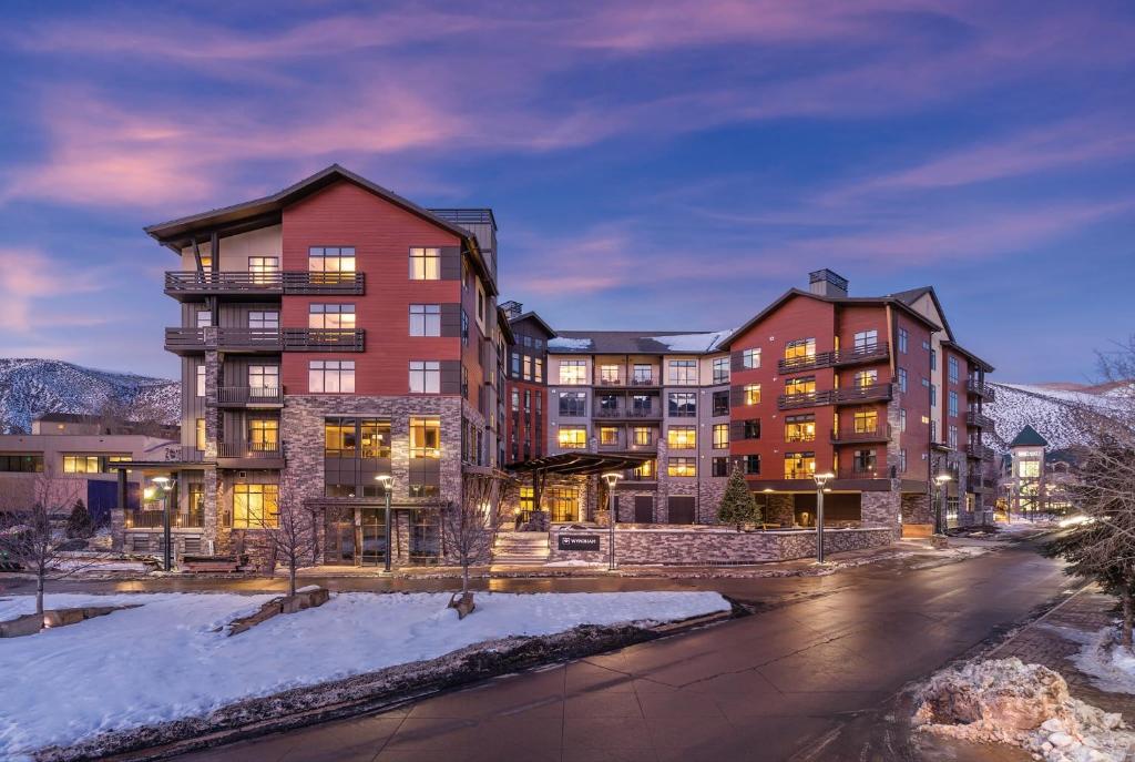 a large apartment building in the snow at night at Avon Resort 2BR Suite in Avon