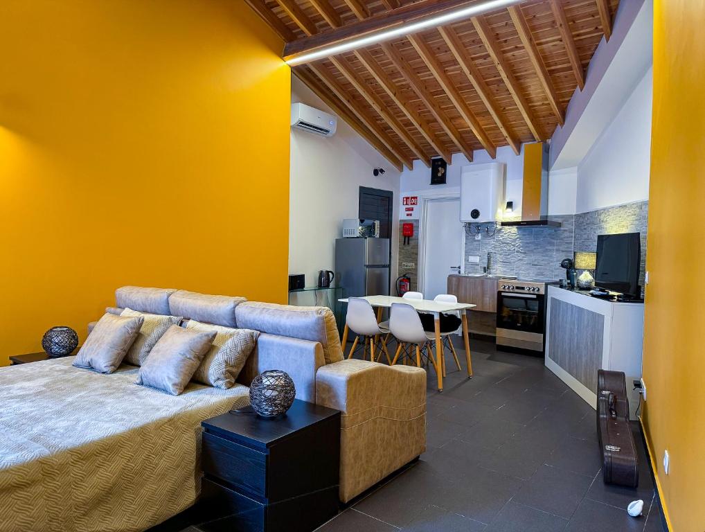 a living room with a couch and a kitchen at Sons da Ribeira in Ribeira Grande