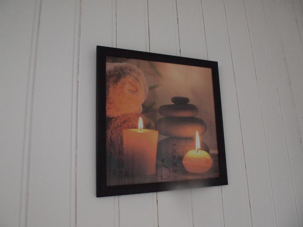 a picture of candles and towels on a wall at Gites de la Haute Ville in Boulogne-sur-Mer