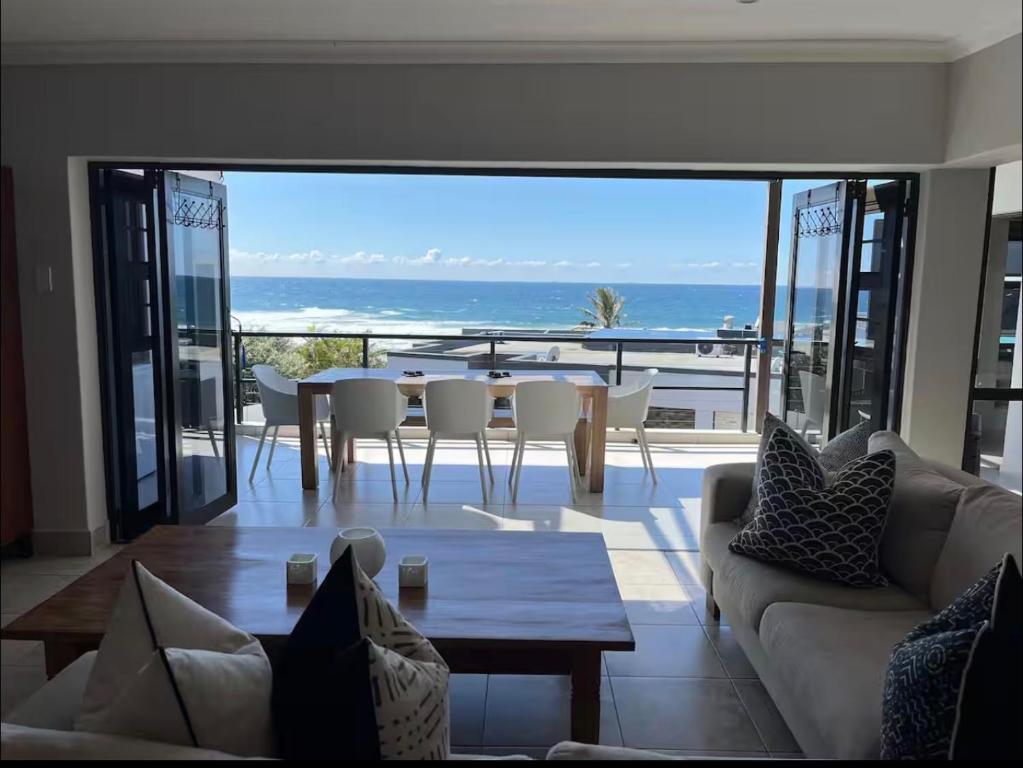 a living room with a view of the ocean at 3 Bedroom - Salt Rock Beach Pad in Ballito