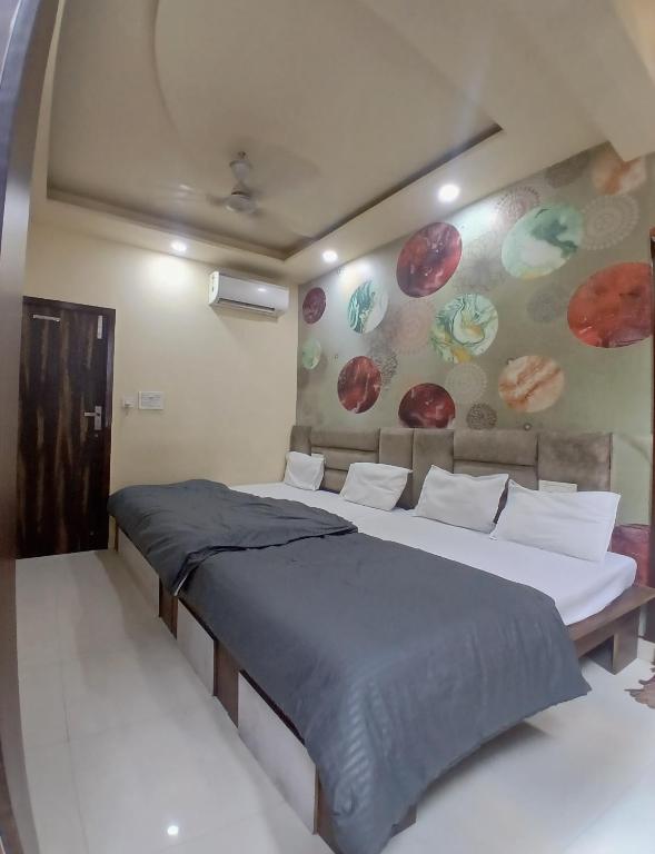 a bedroom with two beds and a wall with planets at Agam Homestay-Two Minutes Walk From Golden Temple in Amritsar