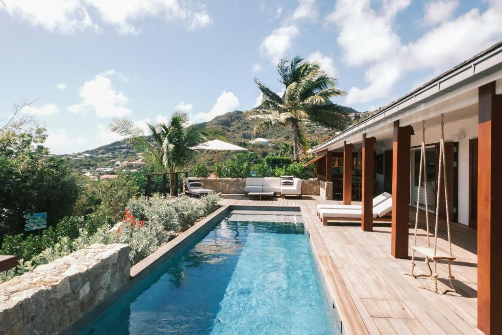 a pool in the backyard of a house at 3 Bedroom Villa with Lagoon View Pool in Marigot