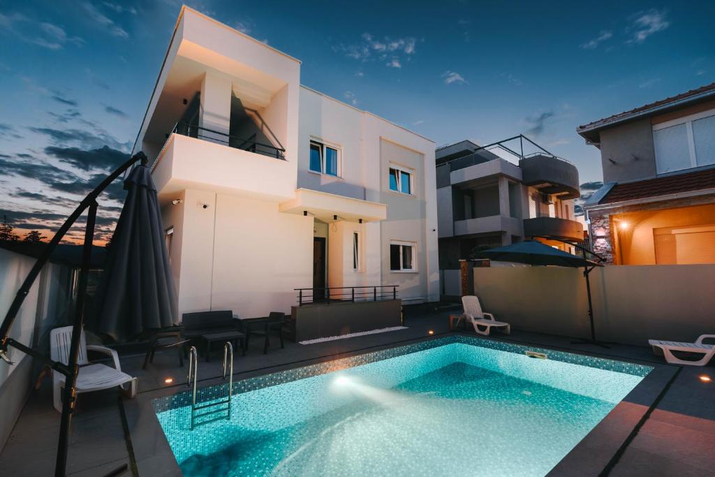a swimming pool in the backyard of a house at Bubbles 2 Apartments in Gevgelija