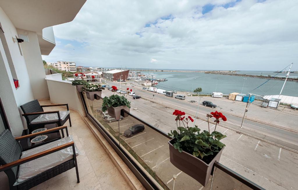 a balcony with a view of a harbor and the ocean at Victory SeaSide Studio in Mangalia