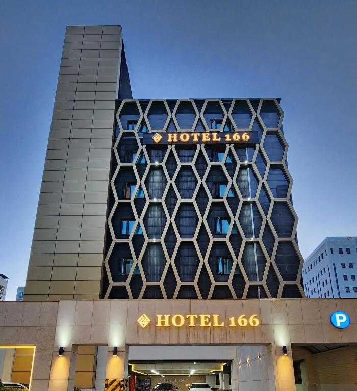 a building with a hotel sign on top of it at Hotel166 in Suwon
