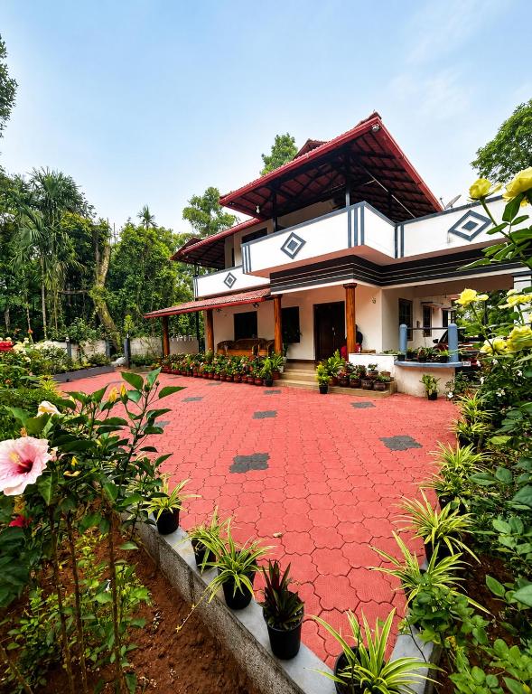 a house with a red brick walkway in front of it at Priyaman Retreat in Madikeri