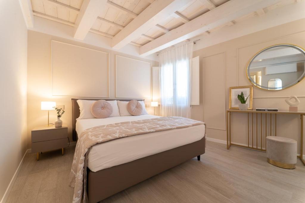 a bedroom with a large bed and a mirror at Residenza Isotta in Rimini