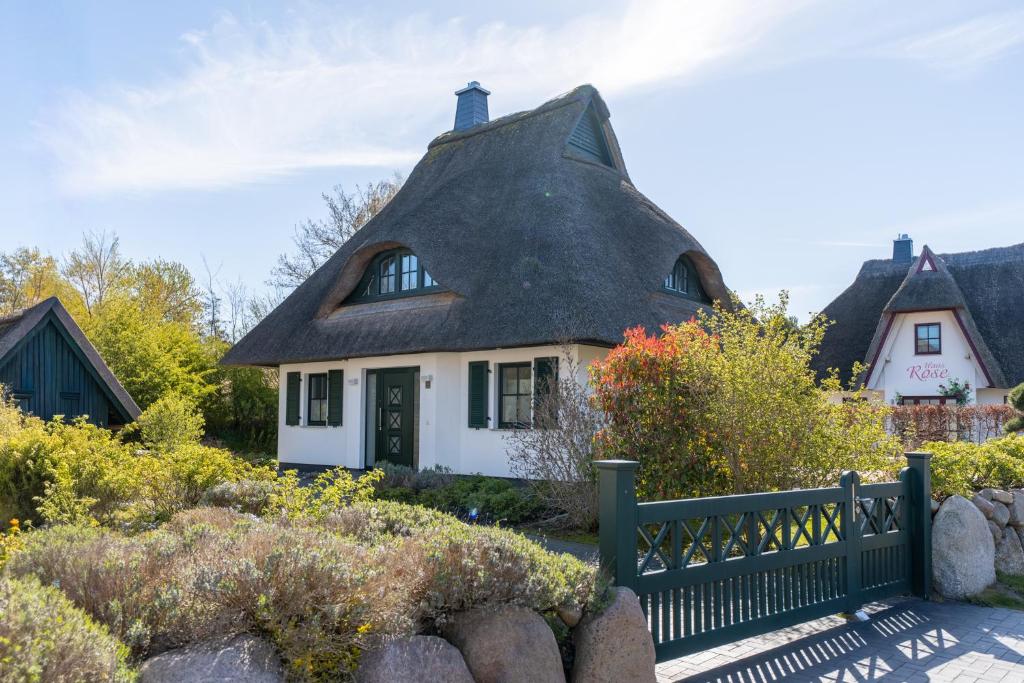 an old house with a thatched roof at Ferienhaus Seeadler 3 in Fuhlendorf