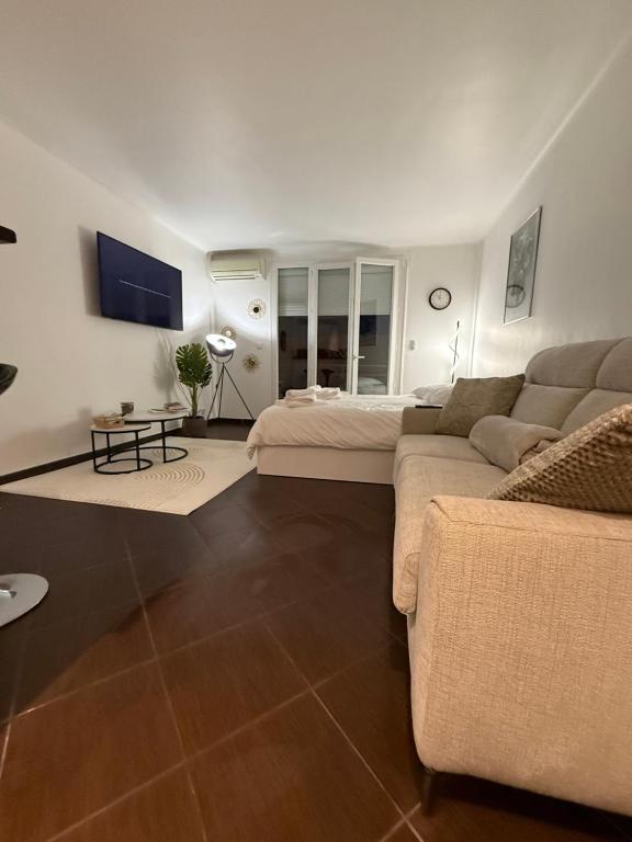 a living room with a couch and a bed at Paula suite avec terrasse-Croisette, Plage Festival Palais in Cannes