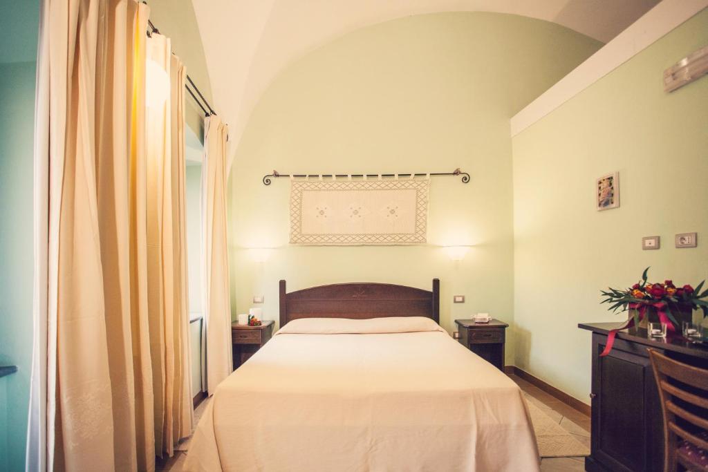 Postel nebo postele na pokoji v ubytování Hotel Il Duomo PHG