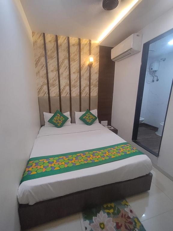 a bedroom with a large bed in a room at Hotel Toss n Sipp Powai in Mumbai