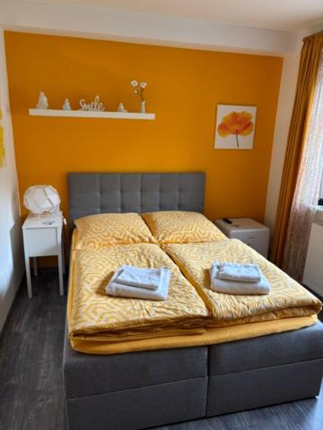 a bedroom with a bed with two towels on it at Apartment Adlerblick in Detmold
