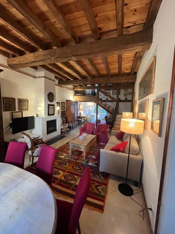 a living room with a table and purple chairs at La Fernandina in Riaza