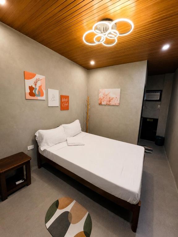a bedroom with a bed and a ceiling fan at Astra Tourist Inn near Airport with high speed free Wifi in Puerto Princesa City
