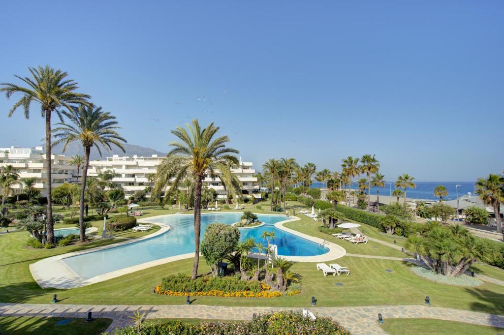 Luxury Beachfront Apt with Private Garden & Pool