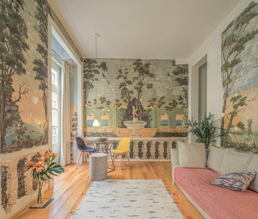 a living room with a couch and a table at Antiga Casa Pessoa in Lisbon