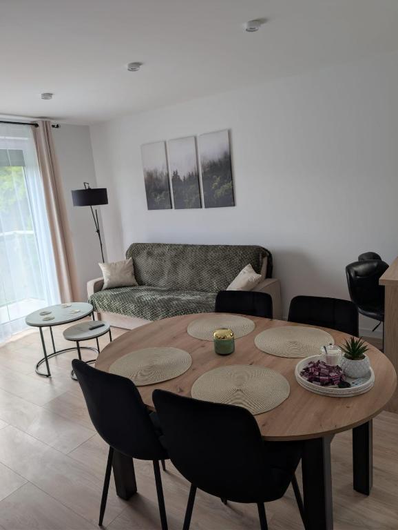 a living room with a table and a couch at Apartament Las in Żagań