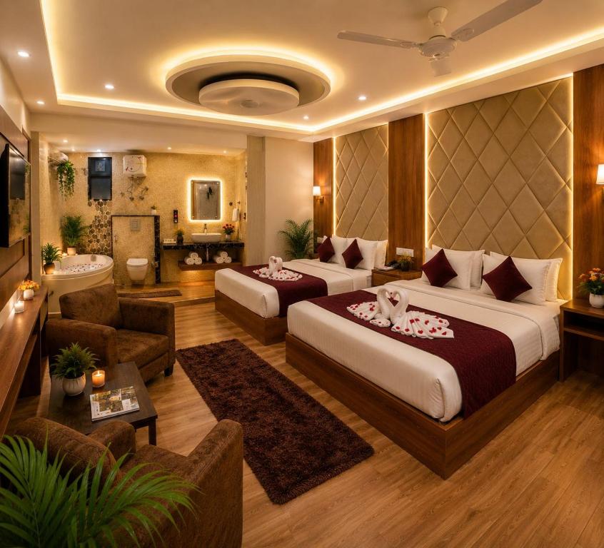 a hotel room with two beds and a bathroom at Hotel Bellwood Near IGI International Delhi Airport in New Delhi
