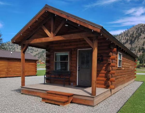 a log cabin with a porch and a door at Micham's Clark Fork River Retreat - River Front, Mountain View, Fire Pit - Cabin 1 in Superior