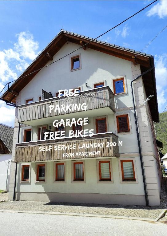 a building with writing on the side of it at Apartments Bohinjc in Bohinj