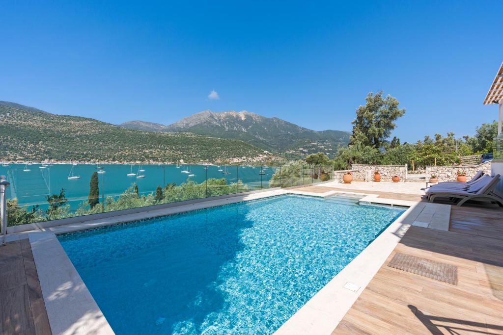 a swimming pool with a view of the water at Villa Helia in Yénion