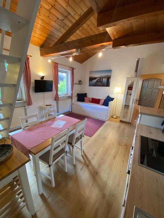 a living room with a table and chairs and a couch at Ferienwohnung Pickert in Bad Endorf