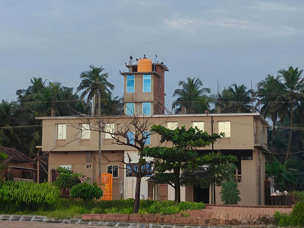 a building with a tower on top of it at Seaside Residency Murudeshwara in Māvalli