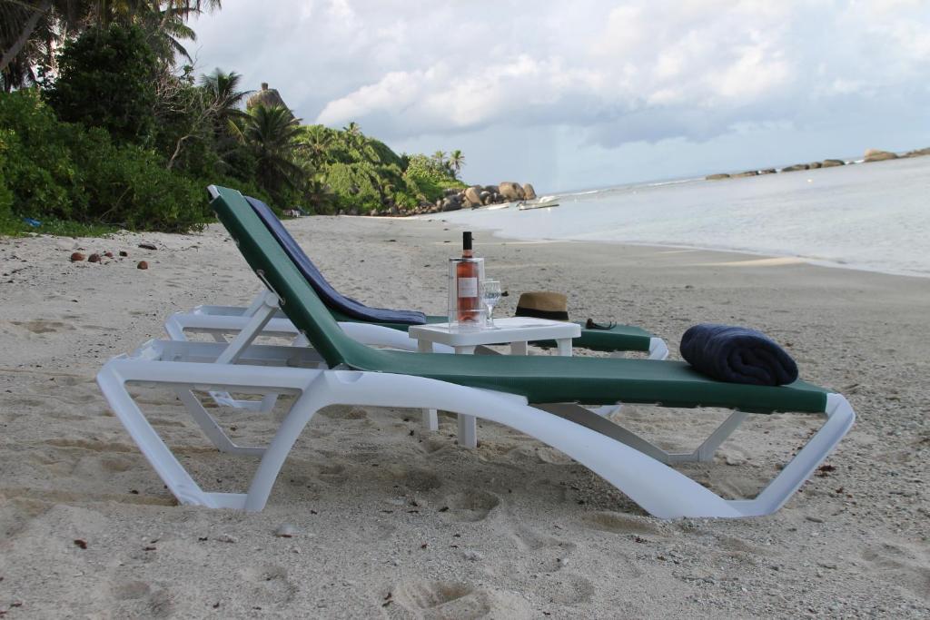 a chair and a table on the beach at Beach Kaz in Takamaka