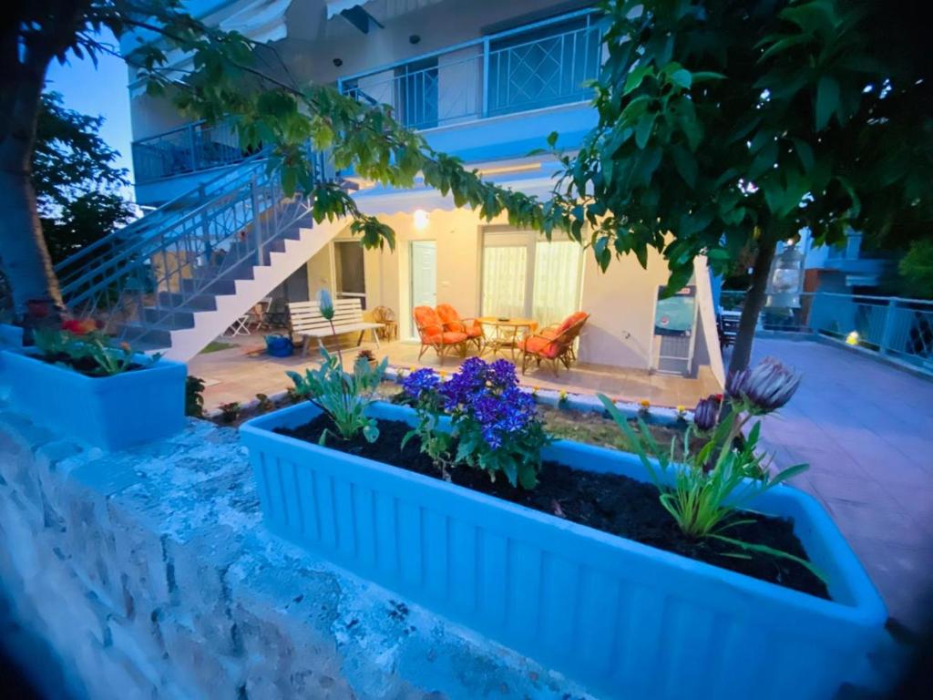 a house with a patio with flowers and plants at Apartment Jorgo Kalithea in Kallithea Halkidikis