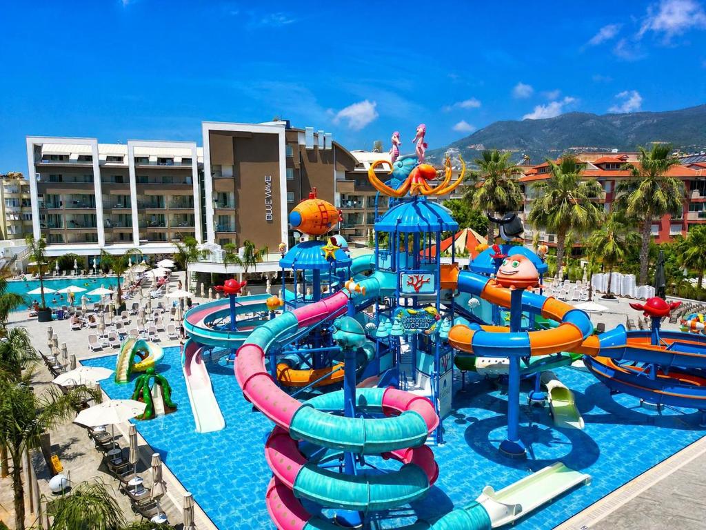 a water park at a resort with a water slide at Blue Wave Suite Hotel in Alanya