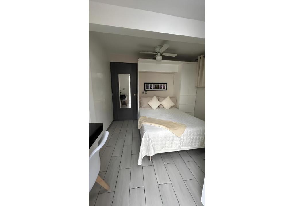 a bedroom with a bed and a ceiling fan at Habitación Tulipán in Oaxaca City