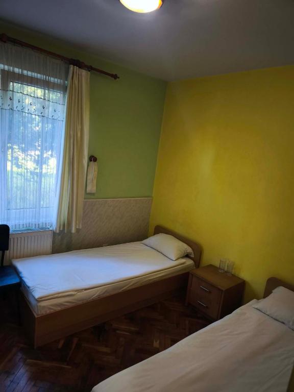 a small room with two beds and a window at Водстрой in Popovo