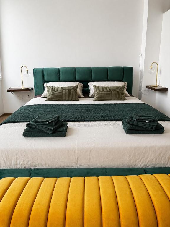 a large bed with two robes on top of it at Studio chic et confortable in Lorgues