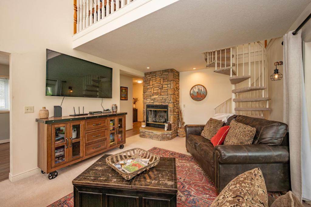 a living room with a couch and a fireplace at Cabin & Canoe by Railey Vacations in McHenry