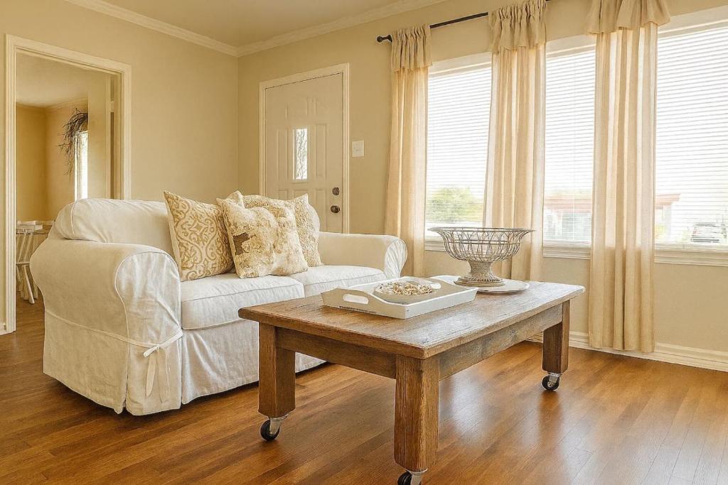a living room with a couch and a coffee table at Cozy Cottage Centrally Located WorkerFriendly in Sherman