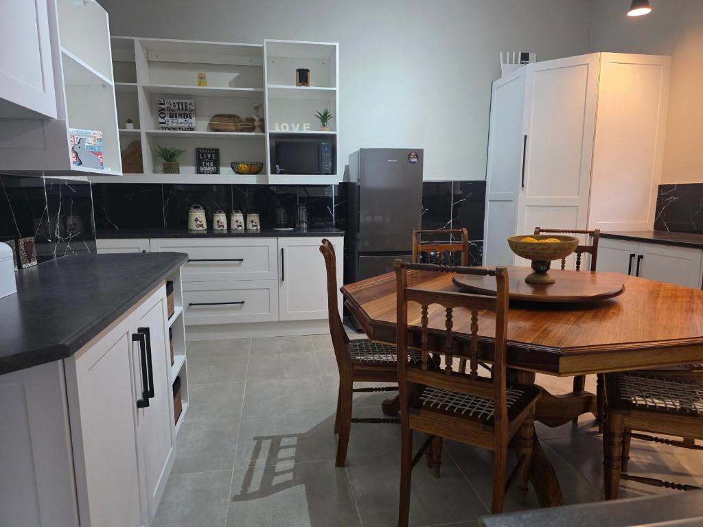 a kitchen with a wooden table and a dining room at 5Res Stay in Queenstown