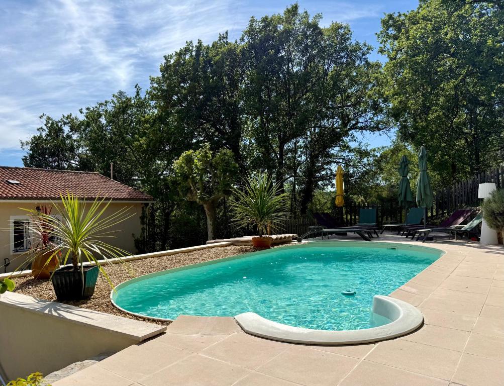 a swimming pool in the middle of a yard at Villa Magrado in Entrecasteaux