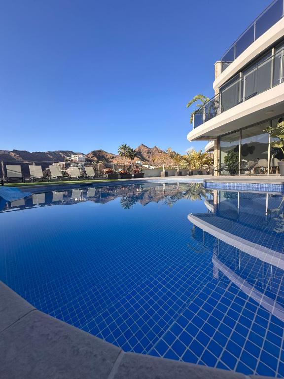 a swimming pool in front of a building at Villa Coco in Mogán