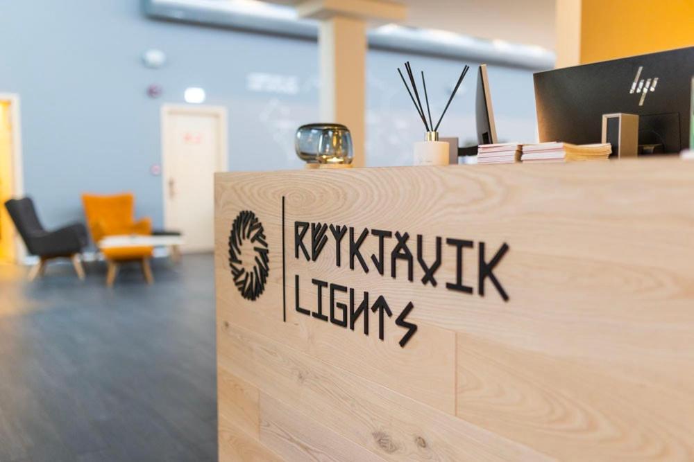 a wooden counter in an office with a sign on it at Reykjavik Lights Hotel by Keahotels in Reykjavík